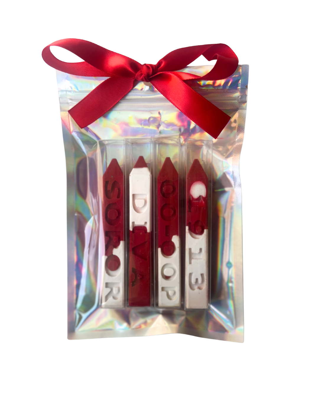 Four red and white crayons in a clear holographic gift bag tied with a red ribbon, on a white background.