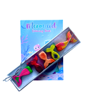 A children's mermaid-themed coloring book with white box holding several colorful mermaid tail crayons, shown on a plain white background.