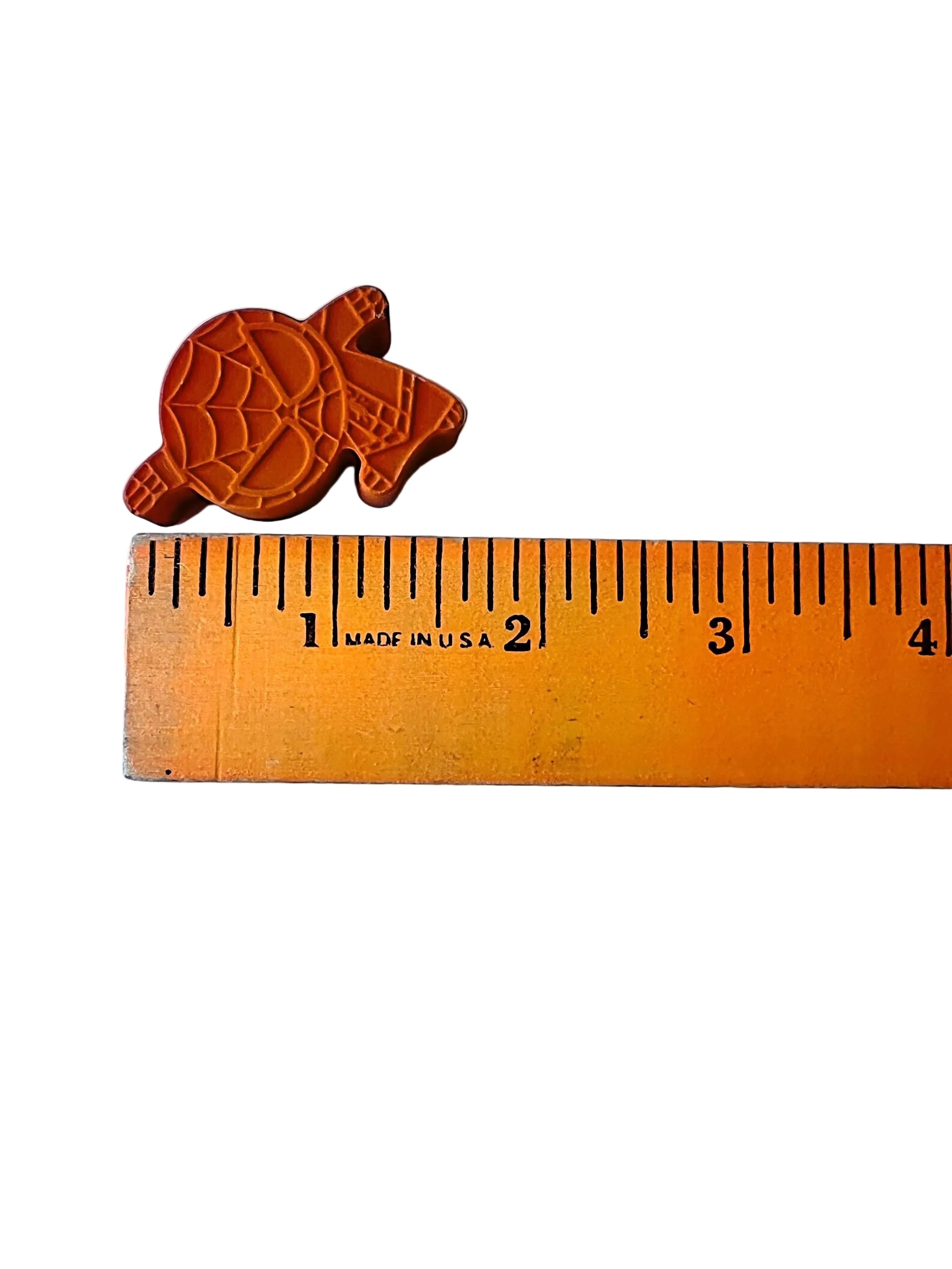 Small superhero crayon next to a ruler